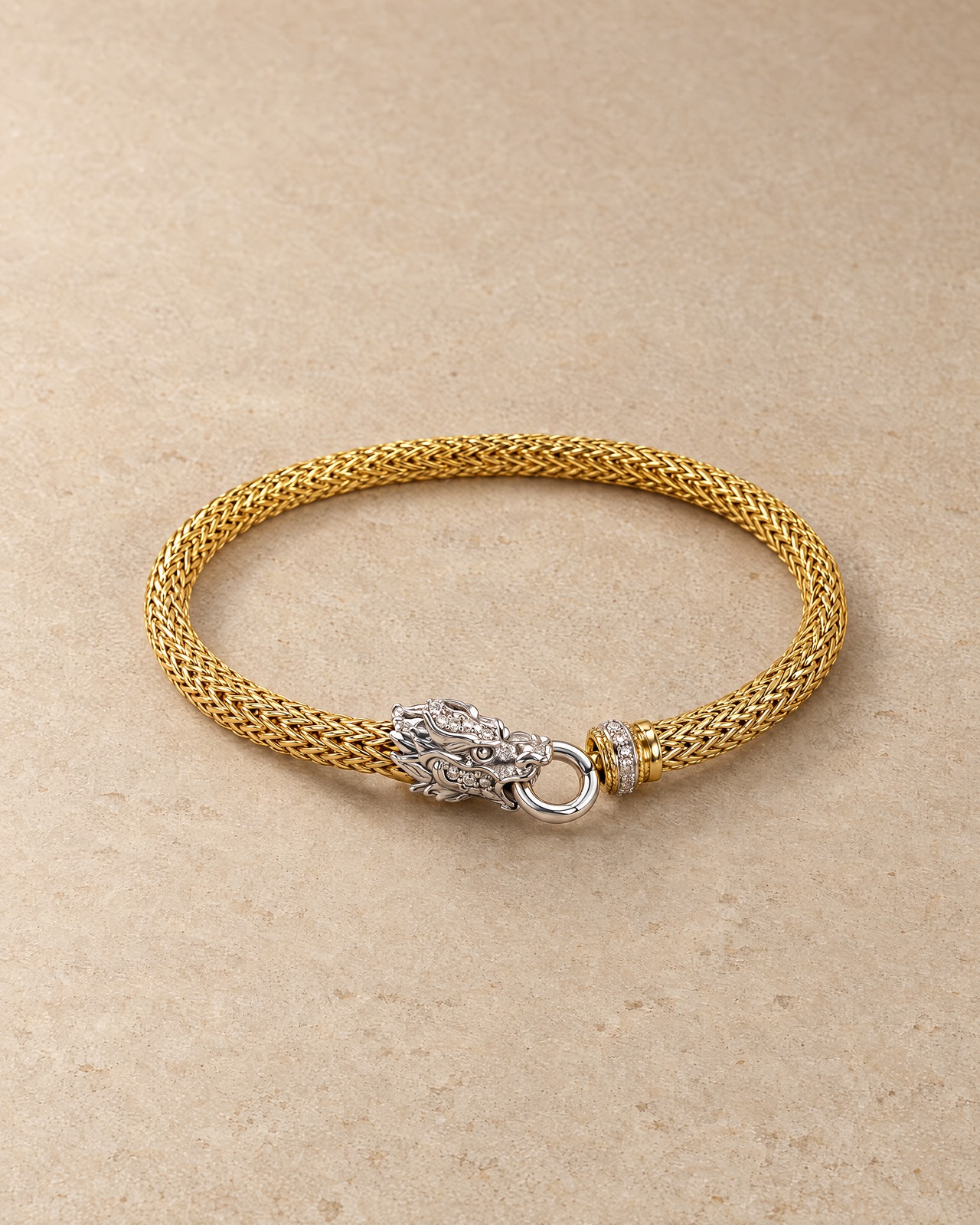 The gold-tone woven dragon bracelet in a still-life photograph