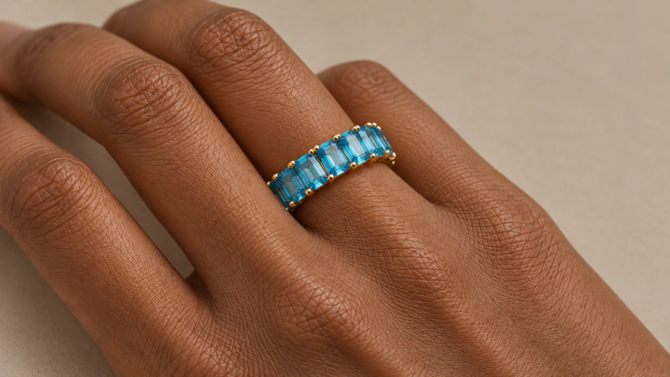 The blue ring worn on a finger in a close view of the hand