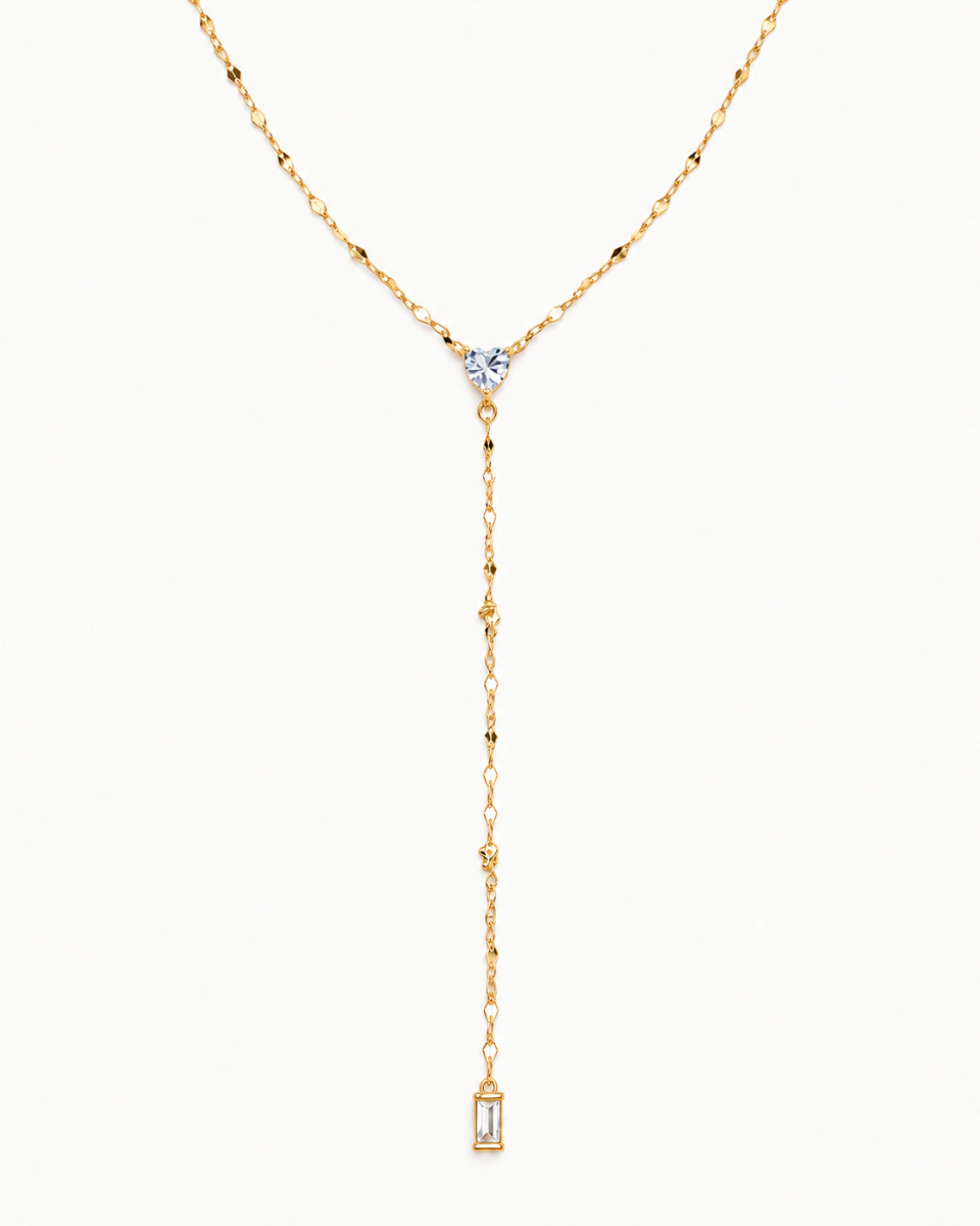 The clear-heart lariat with a fine gold-tone Y chain and narrow clear rectangular drop, on a light background